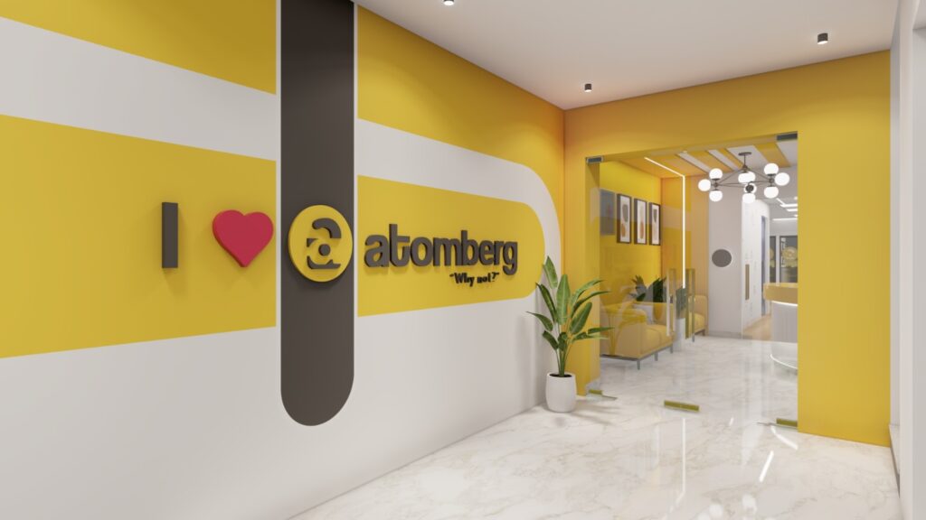 Entrance branding wall designed by Space Studio Chennai for the Atomberg corporate office in Chennai, showcasing the company's brand identity.