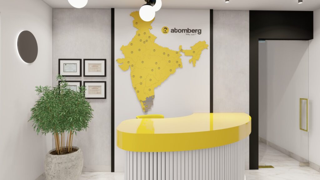 Reception desk with Atomberg branding designed by Space Studio Chennai as part of the corporate office interior in Chennai.